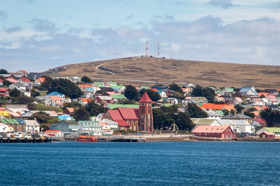Colorful houses and a red-brick church along the harbor in Stanley, Falkland Islands